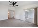Serene bedroom featuring neutral carpet, a ceiling fan, and sliding glass doors for access to the outdoors at 10438 Sw 85Th Ct, Ocala, FL 34481
