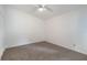 This bedroom features neutral carpet, a ceiling fan and white walls at 10438 Sw 85Th Ct, Ocala, FL 34481