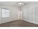 This bedroom features neutral carpet, a window, closet and white walls at 10438 Sw 85Th Ct, Ocala, FL 34481