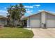 Charming single-story home featuring a well-maintained lawn, covered entry and attached two-car garage at 10438 Sw 85Th Ct, Ocala, FL 34481