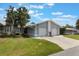Inviting single-story home with a manicured lawn, two-car garage and a welcoming entrance at 10438 Sw 85Th Ct, Ocala, FL 34481