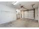 Unfinished garage with door, water heater, and storage shelves at 10438 Sw 85Th Ct, Ocala, FL 34481