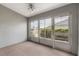 Bright sunroom with carpet and walls of windows at 10438 Sw 85Th Ct, Ocala, FL 34481