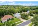 Street view of residence with a brick driveway, two car garage, and mature trees at 1124 Hidden Blf, Clermont, FL 34711