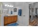 Bathroom featuring warm-toned cabinets, a large mirror, and a blue bath mat at 1124 Hidden Blf, Clermont, FL 34711