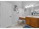 Bathroom featuring a vanity with a large mirror, a stool, and decorative wall art at 1124 Hidden Blf, Clermont, FL 34711