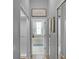 Bathroom with a bathtub, a glass-enclosed shower, and a blue rug at 1124 Hidden Blf, Clermont, FL 34711