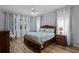 Comfortable bedroom featuring a wooden bed frame, ceiling fan, and lots of natural light at 1124 Hidden Blf, Clermont, FL 34711