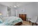 Spacious bedroom with ceiling fan, wood-look floors, a large window, and a closet at 1124 Hidden Blf, Clermont, FL 34711