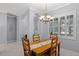 Bright dining room with wood table, chandelier, plantation shutters, and decorative archways at 1124 Hidden Blf, Clermont, FL 34711