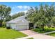 Charming two-story home featuring a well-manicured lawn, brick driveway, and a two-car garage at 1124 Hidden Blf, Clermont, FL 34711