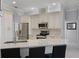 Bright kitchen featuring white cabinets, stainless steel appliances, and granite countertops with bar seating at 1124 Hidden Blf, Clermont, FL 34711