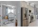 View of a bedroom from the kitchen showcasing stainless steel appliances and countertops at 1124 Hidden Blf, Clermont, FL 34711