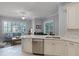 Open kitchen featuring stainless steel appliances and granite countertops that flows into the living area at 1124 Hidden Blf, Clermont, FL 34711