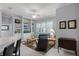 Living room with custom built-in shelving and plantation shutters that bring in natural light at 1124 Hidden Blf, Clermont, FL 34711
