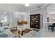 Open concept living space with modern furniture, flowing into the kitchen and dining area at 1124 Hidden Blf, Clermont, FL 34711