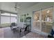 Cozy screened porch with comfortable seating, ceiling fan, and access to the outdoors at 1124 Hidden Blf, Clermont, FL 34711