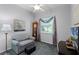 Relaxing sitting room with comfortable seating, grandfather clock, and large window at 1124 Hidden Blf, Clermont, FL 34711