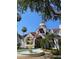 Attractive two-story building with red awnings, lush landscaping, and a charming fountain at 11582 Westwood Blvd # 1428, Orlando, FL 32821
