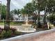 Community entrance with a water fountain and landscaping, surrounded by mature trees at 11582 Westwood Blvd # 1428, Orlando, FL 32821