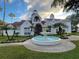Attractive two-story building with red awnings, lush landscaping, and a charming fountain at 11582 Westwood Blvd # 1428, Orlando, FL 32821