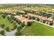 Wide aerial view of the community with ponds, a golf course, and mature trees at 11937 Bianca Ln, Orlando, FL 32827