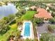 Aerial view of the community pool, clubhouse, and lake with winding walking path at 11937 Bianca Ln, Orlando, FL 32827