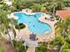 Aerial view of the clover shaped pool at the community clubhouse with ample lounge seating at 11937 Bianca Ln, Orlando, FL 32827