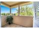 This covered balcony features white columns and beautiful views of the green landscape at 11937 Bianca Ln, Orlando, FL 32827