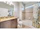 Cozy bathroom with granite countertops, wood vanity, and a shower/tub combo with tiled walls at 11937 Bianca Ln, Orlando, FL 32827