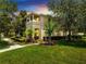 Inviting two-story home featuring a charming balcony and beautifully landscaped front yard at 11937 Bianca Ln, Orlando, FL 32827