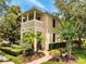 Well-maintained two-story home with a balcony, complemented by lush landscaping and a brick walkway at 11937 Bianca Ln, Orlando, FL 32827