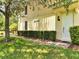 Charming front door with brick pathway, surrounded by green landscaping and a mature tree at 11937 Bianca Ln, Orlando, FL 32827