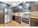 Spacious kitchen featuring stainless steel appliances, granite countertops and dark wood cabinetry at 11937 Bianca Ln, Orlando, FL 32827
