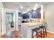 Modern kitchen with stainless steel appliances, granite countertops, and a breakfast bar with seating at 11937 Bianca Ln, Orlando, FL 32827