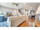 Open-concept living room with hardwood floors, a ceiling fan, and a staircase at 11937 Bianca Ln, Orlando, FL 32827