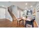 Open-concept living area with hardwood floors, a dining table, and staircase leading to the second floor at 11937 Bianca Ln, Orlando, FL 32827