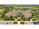 Aerial view of the beautiful community clubhouse, landscaping, and a calm lake in the background at 13452 Sagestone Dr, Winter Garden, FL 34787