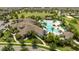 Bird's eye view of community pool with ample seating and lush landscaping around the clubhouse at 13452 Sagestone Dr, Winter Garden, FL 34787