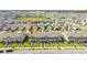 High aerial view showcases a well-planned community with uniform townhomes, green spaces, and orderly streets at 13452 Sagestone Dr, Winter Garden, FL 34787