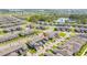 Sweeping aerial perspective of a community with organized townhomes, surrounding roads, and picturesque lakes in the distance at 13452 Sagestone Dr, Winter Garden, FL 34787