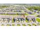 Beautiful aerial view of townhomes in a well-maintained community with lush landscaping and proximity to a lake at 13452 Sagestone Dr, Winter Garden, FL 34787