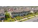 Aerial shot of a neighborhood showcasing the townhome with a well-designed roof and manicured landscaping at 13452 Sagestone Dr, Winter Garden, FL 34787