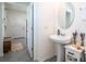 Powder room features white fixtures, neutral walls, and tile flooring at 13452 Sagestone Dr, Winter Garden, FL 34787