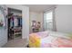This bedroom features a walk-in closet, stylish vanity with lighted mirror, and comfortable carpet at 13452 Sagestone Dr, Winter Garden, FL 34787