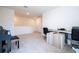 Bright and airy space used as a loft, showcasing neutral carpeting, a desk area and piano at 13452 Sagestone Dr, Winter Garden, FL 34787