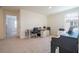 Bright office and music room featuring a modern desk area, a piano, and neutral carpeting at 13452 Sagestone Dr, Winter Garden, FL 34787