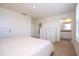 Bedroom featuring a view of the bathroom and a white dresser with drawers at 13452 Sagestone Dr, Winter Garden, FL 34787