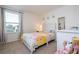 Bright bedroom with colorful bedding, neutral carpet, and window with ample natural light at 13452 Sagestone Dr, Winter Garden, FL 34787
