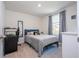 Bedroom features a large window with curtains, a mirror, modern furniture and neutral carpet at 13452 Sagestone Dr, Winter Garden, FL 34787